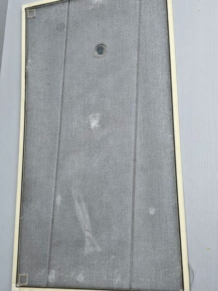 Window screen before repair, torn and dirty