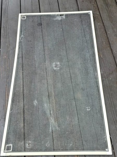 Old dirty window screen before repair